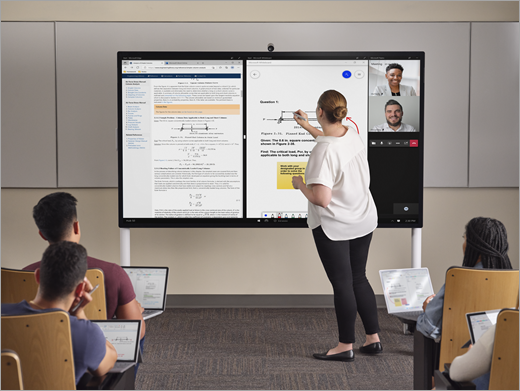 An educator in a hybrid classroom with students joining class in-person and over a Teams call.