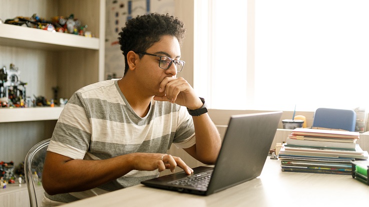 photo of a student working on a laptop