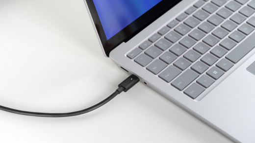 A Surface laptop device being charged with a USB-C cable.