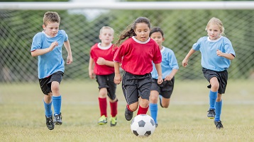 photo of children on a sports team playing in a tournament