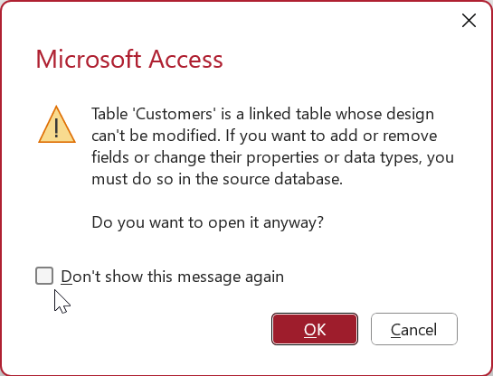 Warning message in Access about opening a linked table in Design view. A checkbox labeled Don't show this message again is being selected.