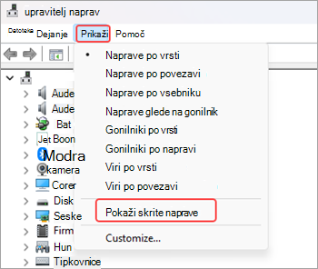 Posnetek zaslona okna upravitelj naprav  z izbrano možnostjo »Pogled« na traku menija in označeno možnostjo »Pokaži skrite naprave« z rdečo.