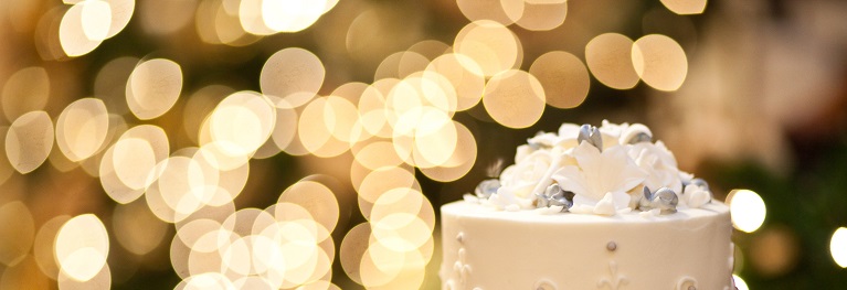 Photo of a wedding cake with blurred lights in the background